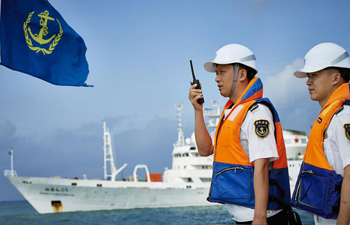 Crew members check China's manned deep-sea submersible Jiaolong in Sanya